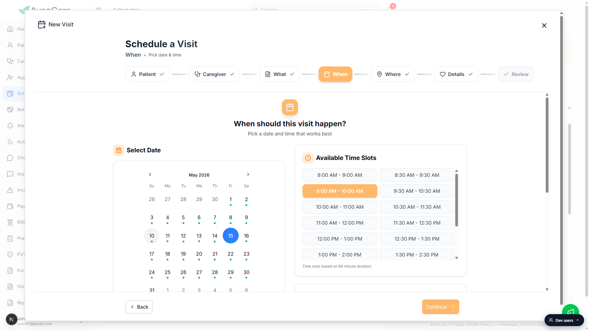 When step of the Schedule a Visit wizard with the May 2026 calendar on the left, the date 15 selected, and the Available Time Slots panel on the right showing 9:00 AM to 10:00 AM highlighted in orange