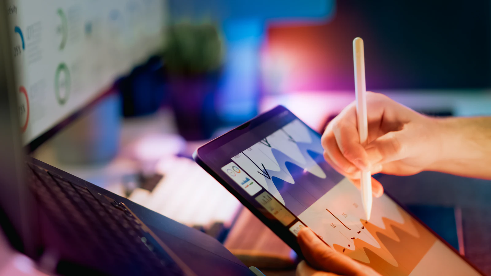 Manager reviewing home care KPI charts on a tablet with a stylus