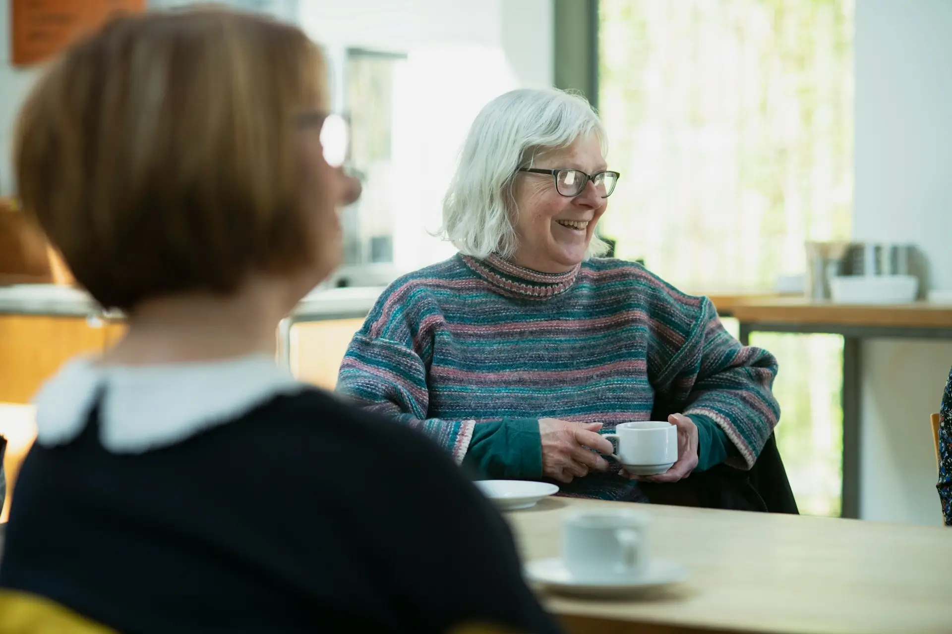 Elderly women talking together, representing the social benefits of respite care services